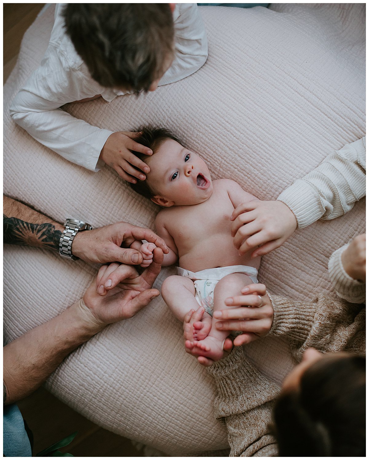 Newborn Baby with Hands of her Family Indoor Newborn Photography