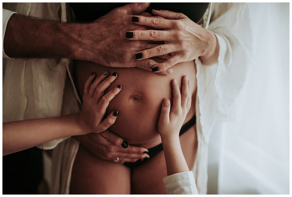 Maternity Photography Session in your own home with Family.  Hands on the belly.
