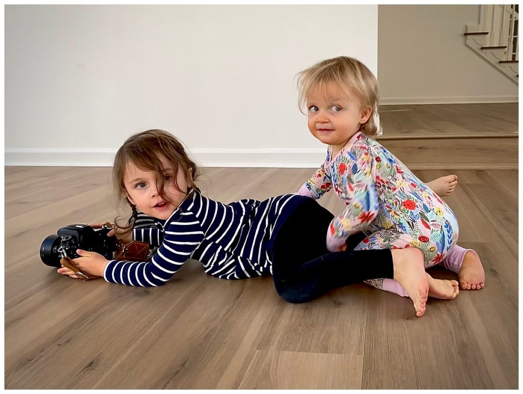 Sisters playing on the floor with a Nikon camera smart phone photography tips