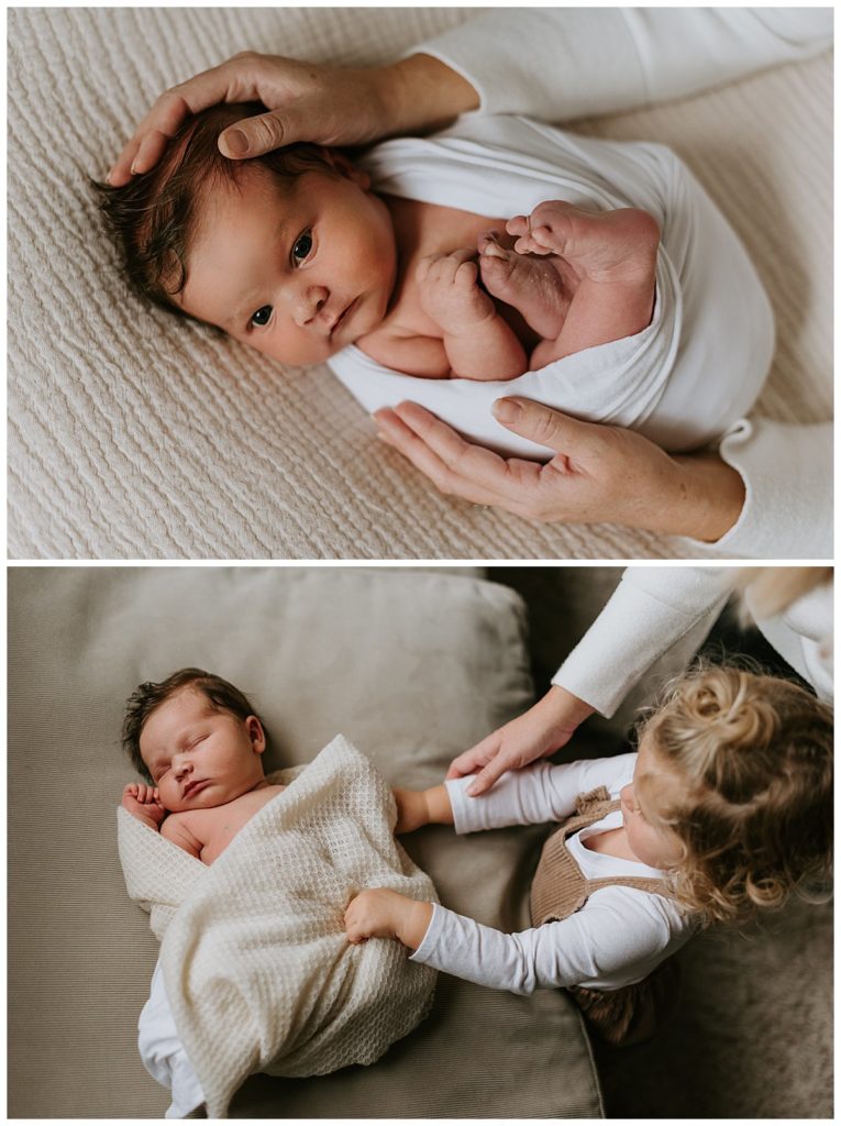 Posed Newborn Portraits in the hands of her father and swaddled in a white wrap during her indoor newborn photography session in Philadelphia Pennsylvania