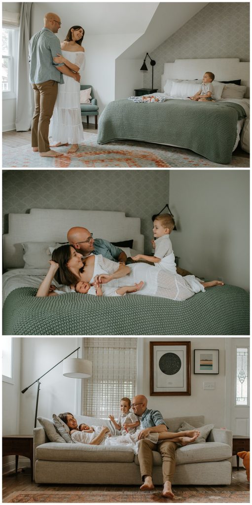 A couple dances in their room while their son and newborn baby relax on the bed during their family photography session in Philadelphia