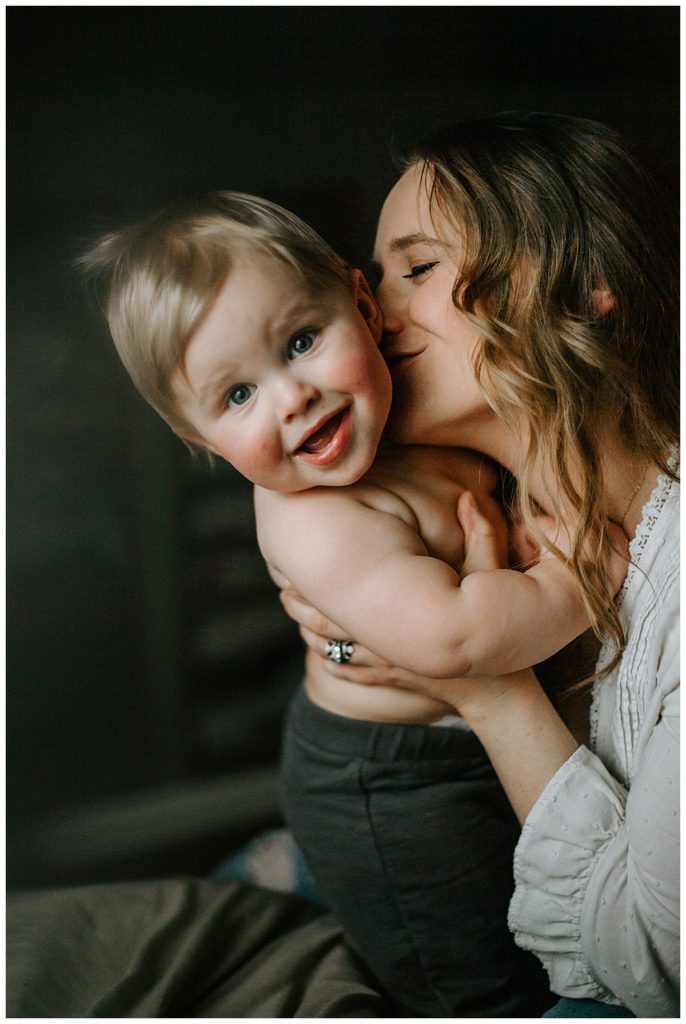 a mother kissing her baby is one of Three Reasons to hire a Photographer