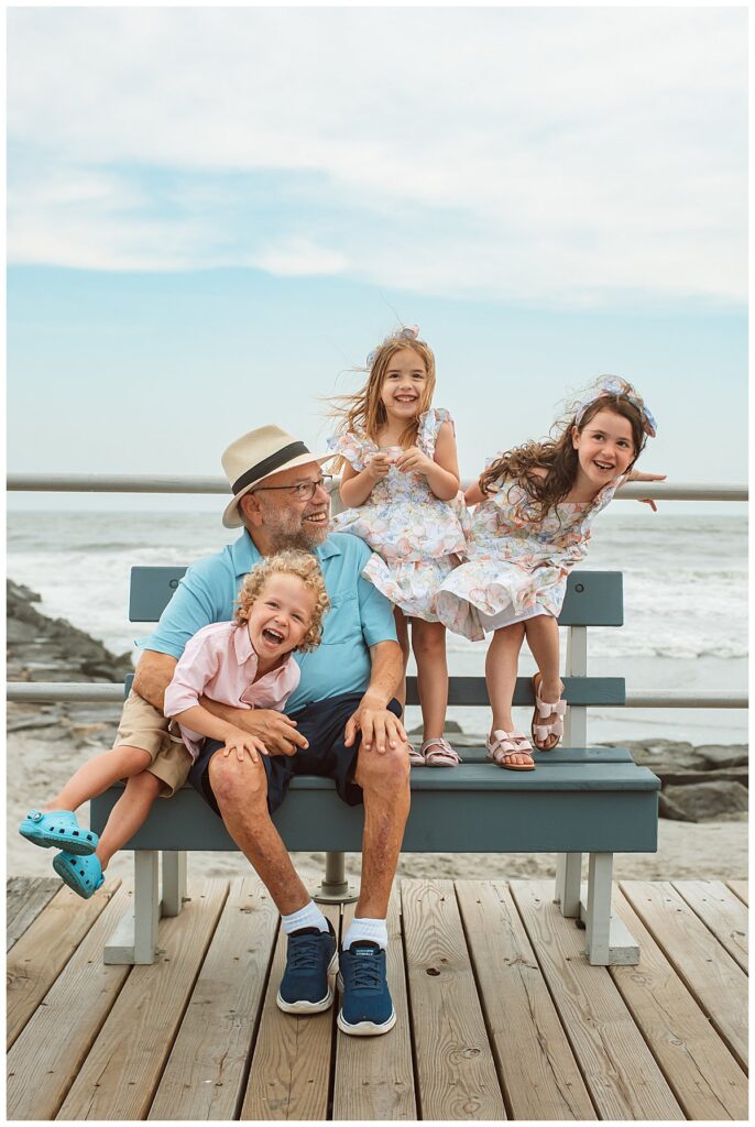 Family Photos at Ocean City New Jersey Grandfather sits with his grandchildren in OCNJ for the family photos at the shore